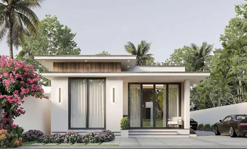 Nhà cấp 4 mái bằng có khoảng sân trước trồng cây nhỏ xen lối đi lát đá, vừa tạo điểm nhấn xanh mát vừa tăng tính thẩm mỹ