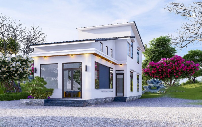 Sân trước lát đá xám nhám, điểm xuyết bằng tiểu cảnh xanh mướt giúp công trình thêm sinh động